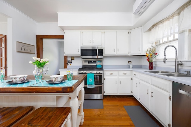 7365 S Broadway, Red Hook, NY 12571 - kitchen with a sink, appliances with stainless steel finishes, white cabinets, and ornamental molding