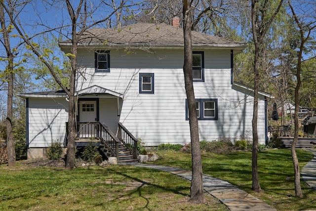 view of front facade featuring a front lawn and a chimney