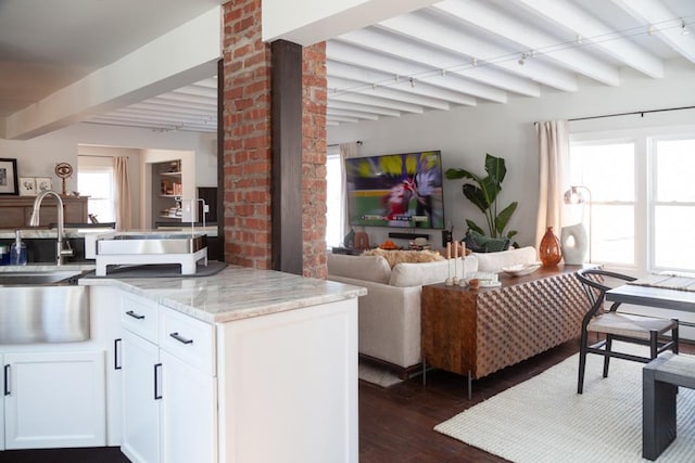 interior space with dark wood finished floors and beamed ceiling