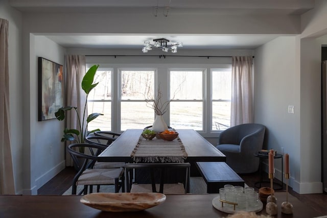 dining area with baseboards and wood finished floors