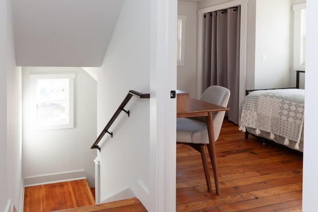 staircase with wood-type flooring and baseboards