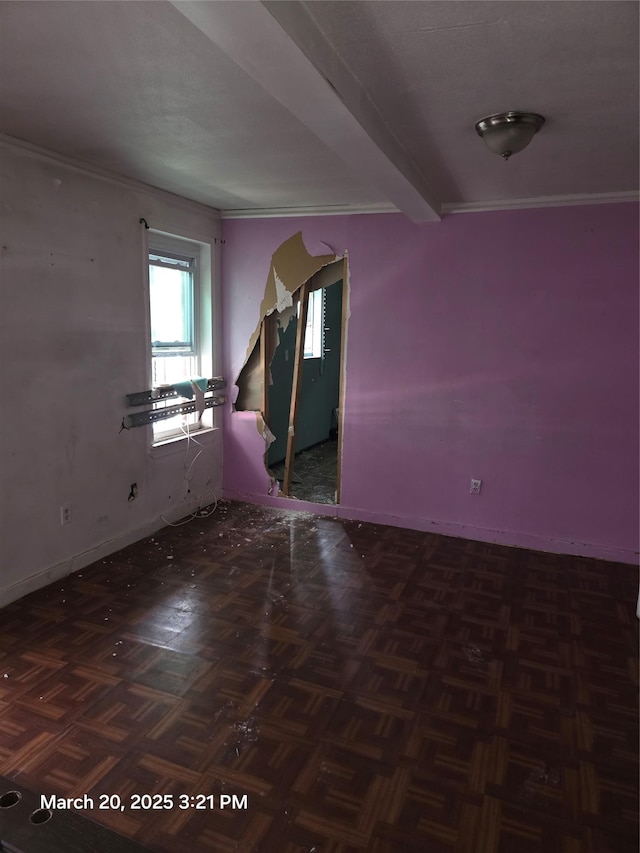 unfurnished room featuring crown molding and baseboards