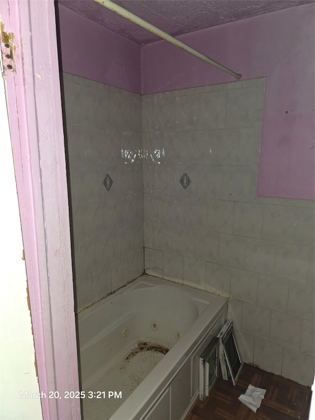 full bathroom with tile walls and a combined bath / shower with jetted tub