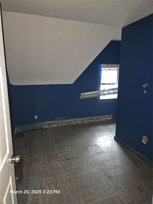 bonus room featuring baseboards and vaulted ceiling
