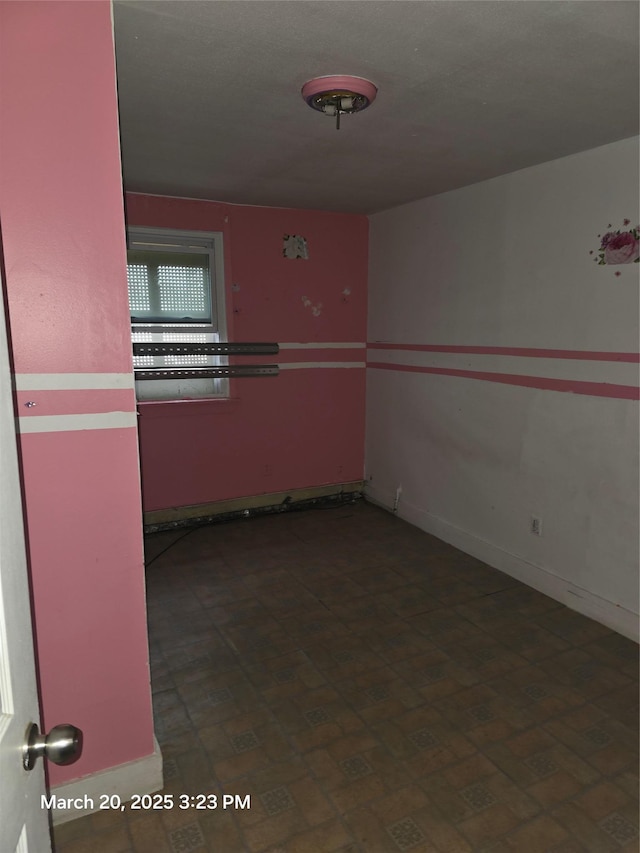 spare room featuring baseboards