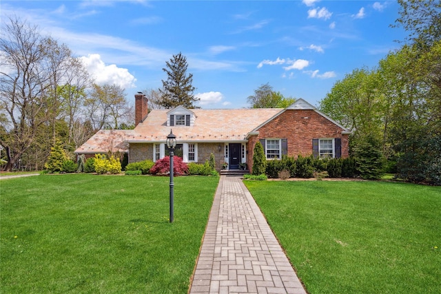 26 Woodgreen Ln, East Hills, NY 11577 - view of front of property with a chimney, a front yard, and brick siding