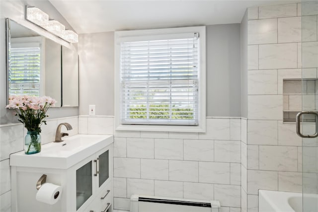 26 Woodgreen Ln, East Hills, NY 11577 - bathroom with a baseboard radiator, tile walls, lofted ceiling, and vanity