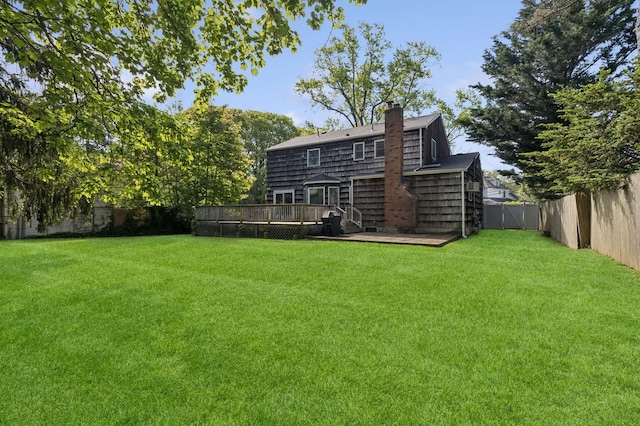 126 Carley Ave, Huntington, NY 11743 - rear view of property featuring a wooden deck, a chimney, and a shingled roof