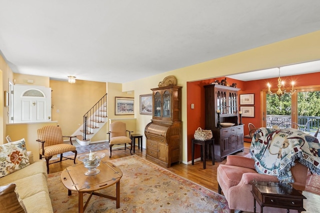126 Carley Ave, Huntington, NY 11743 - living room featuring light wood finished floors, a chandelier, and stairs
