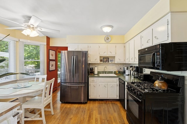 126 Carley Ave, Huntington, NY 11743 - kitchen featuring black appliances, a sink, ceiling fan, tasteful backsplash, and white cabinetry