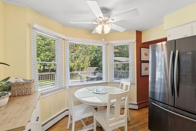 126 Carley Ave, Huntington, NY 11743 - dining area with a baseboard radiator, healthy amount of natural light, ceiling fan, and light wood finished floors