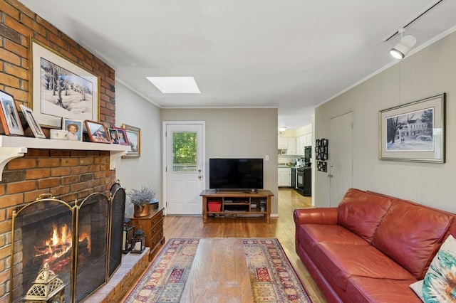 126 Carley Ave, Huntington, NY 11743 - living area featuring a skylight, wood finished floors, crown molding, and a fireplace