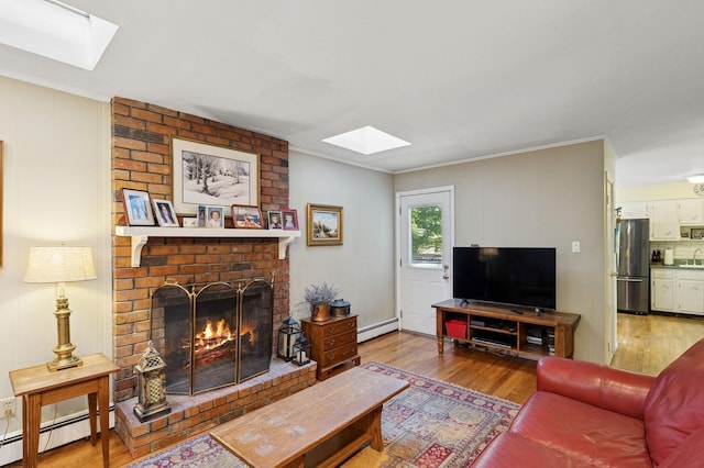 126 Carley Ave, Huntington, NY 11743 - living area featuring a skylight, a baseboard radiator, wood finished floors, and ornamental molding