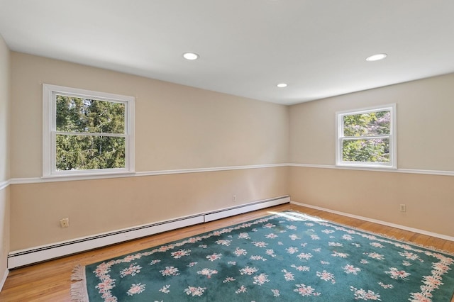 126 Carley Ave, Huntington, NY 11743 - unfurnished room featuring a baseboard heating unit, wood finished floors, baseboards, and recessed lighting