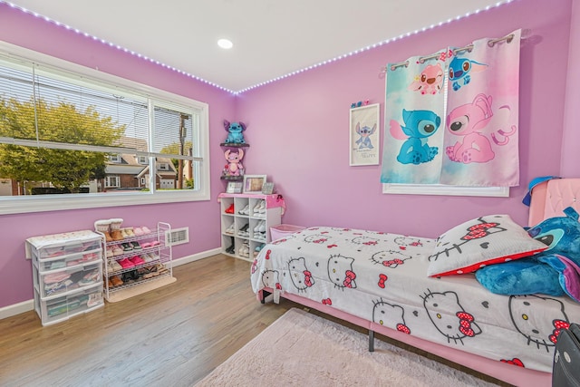 bedroom with baseboards, recessed lighting, and wood finished floors