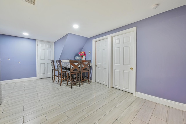 dining space with recessed lighting, baseboards, light wood finished floors, and visible vents
