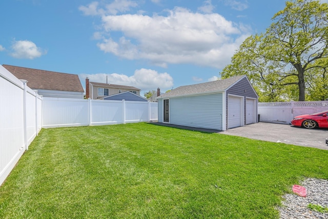 view of yard with a fenced backyard, an outbuilding, and a detached garage