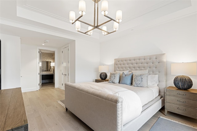 bedroom featuring connected bathroom, baseboards, a chandelier, and light wood-type flooring