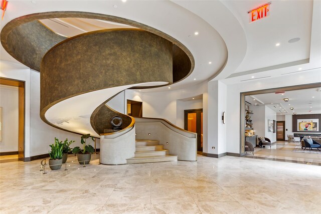 entrance foyer with stairway, baseboards, and recessed lighting