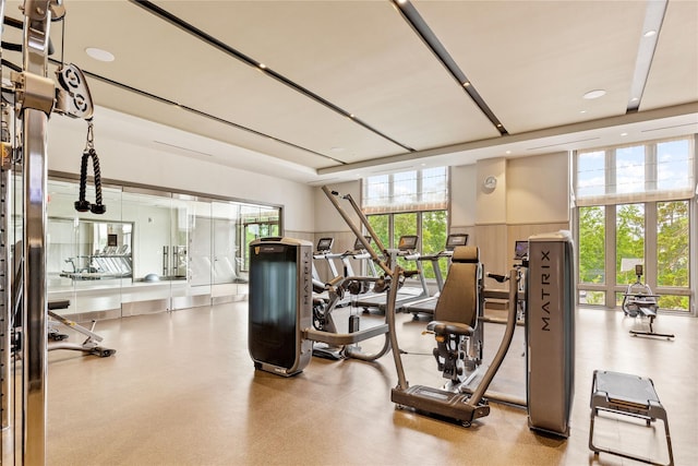workout area featuring recessed lighting and a wainscoted wall