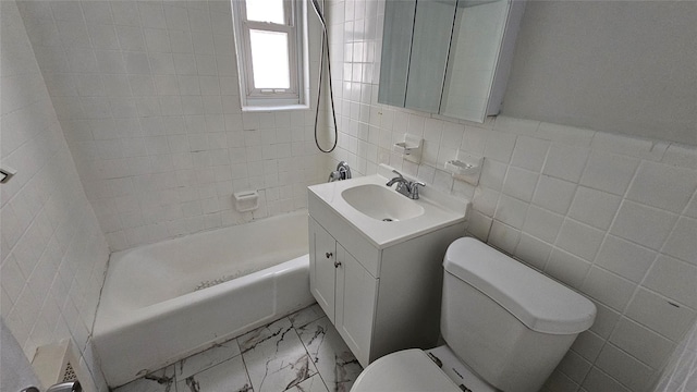 full bathroom with vanity, marble finish floor, bathing tub / shower combination, toilet, and tile walls