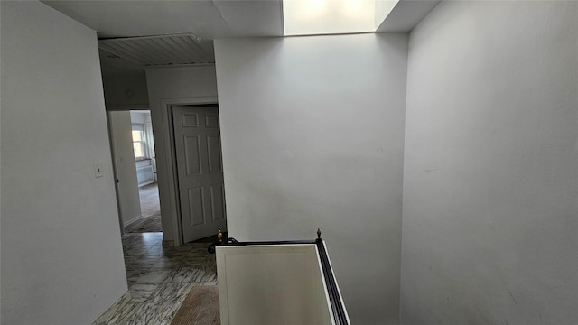 hall with marble finish floor