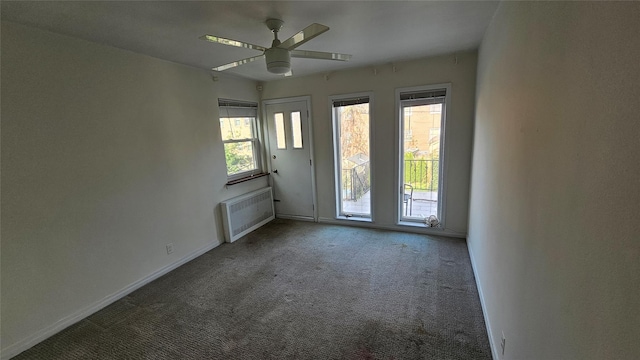 spare room with carpet flooring, a ceiling fan, and baseboards