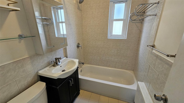 bathroom with shower / bathing tub combination, tile walls, vanity, toilet, and radiator