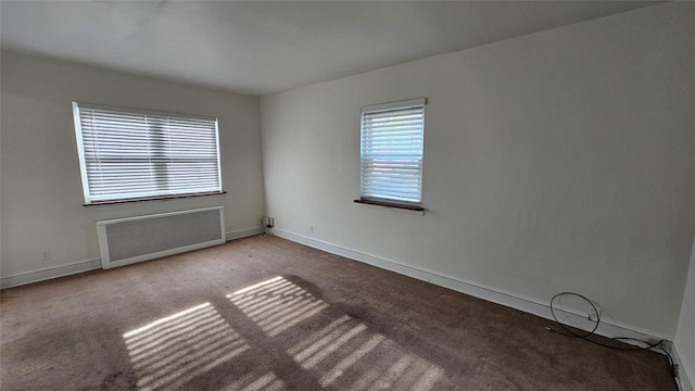 40-19 196th St, Flushing, NY 11358 - empty room with radiator, carpet flooring, and baseboards