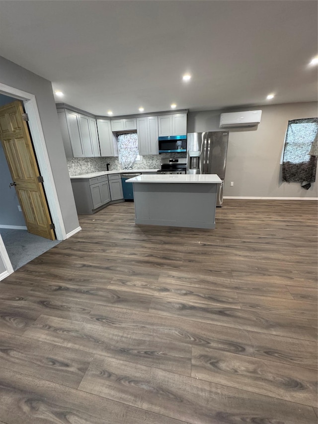 1161 E 88th St, Brooklyn, NY 11236 - kitchen featuring appliances with stainless steel finishes, gray cabinetry, a wall mounted air conditioner, dark wood-type flooring, and recessed lighting