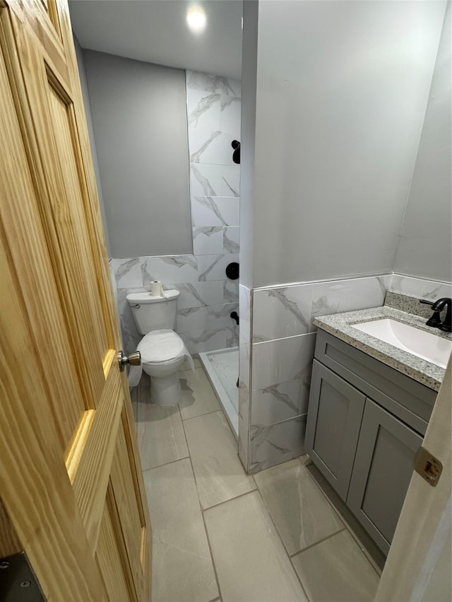 1161 E 88th St, Brooklyn, NY 11236 - full bath with tile walls, toilet, a shower stall, vanity, and wainscoting