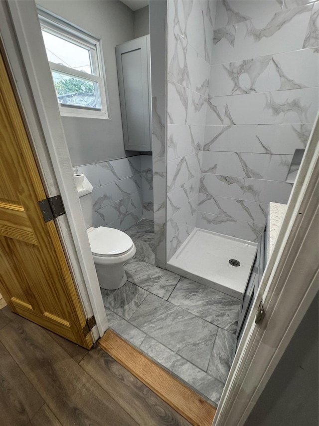 1161 E 88th St, Brooklyn, NY 11236 - bathroom with toilet, a shower stall, tile walls, wainscoting, and wood finished floors