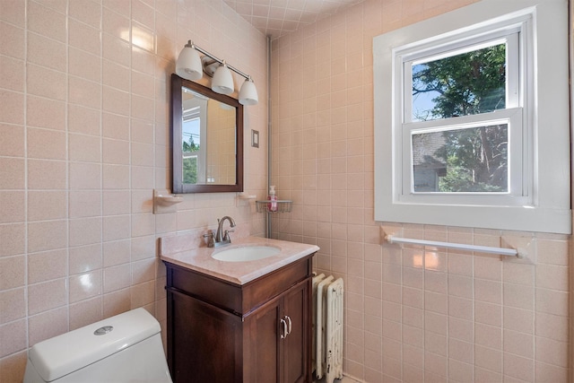 119 Western Hwy, West Nyack, NY 10994 - bathroom with toilet, tile walls, a wealth of natural light, and radiator heating unit
