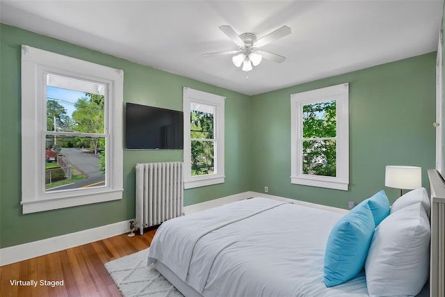 119 Western Hwy, West Nyack, NY 10994 - bedroom with radiator, multiple windows, baseboards, and wood finished floors