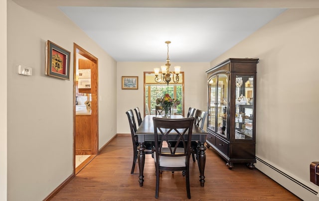dining space featuring an inviting chandelier, baseboards, wood finished floors, and baseboard heating