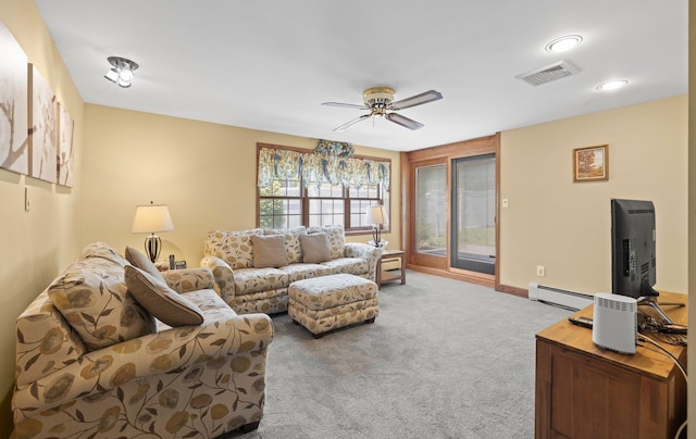 carpeted living area featuring visible vents, baseboards, recessed lighting, a baseboard heating unit, and a ceiling fan