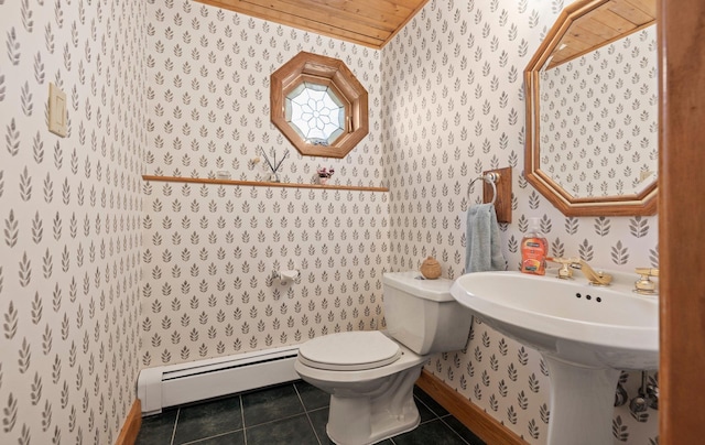 bathroom featuring baseboards, a baseboard radiator, wallpapered walls, and tile patterned flooring