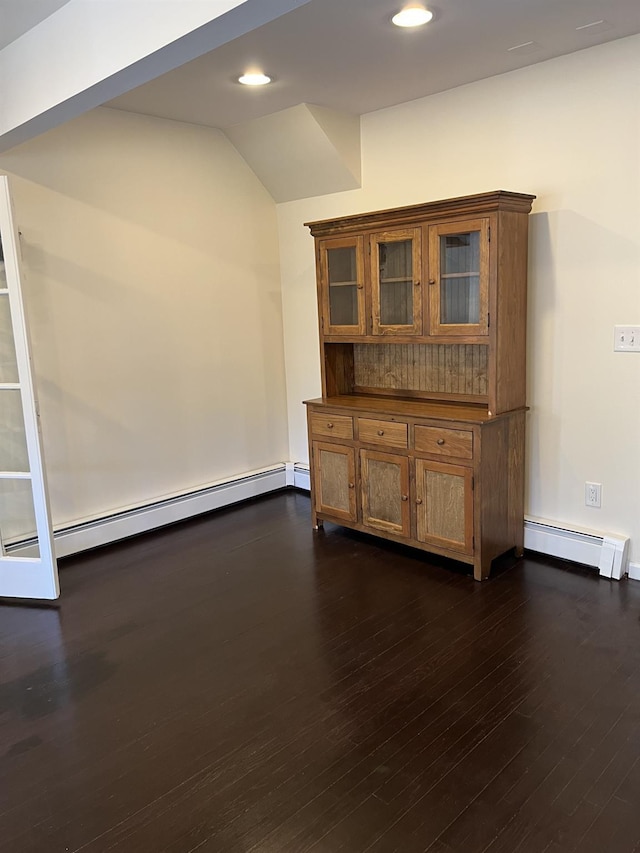 interior space featuring recessed lighting, a baseboard radiator, lofted ceiling, and dark wood-style floors