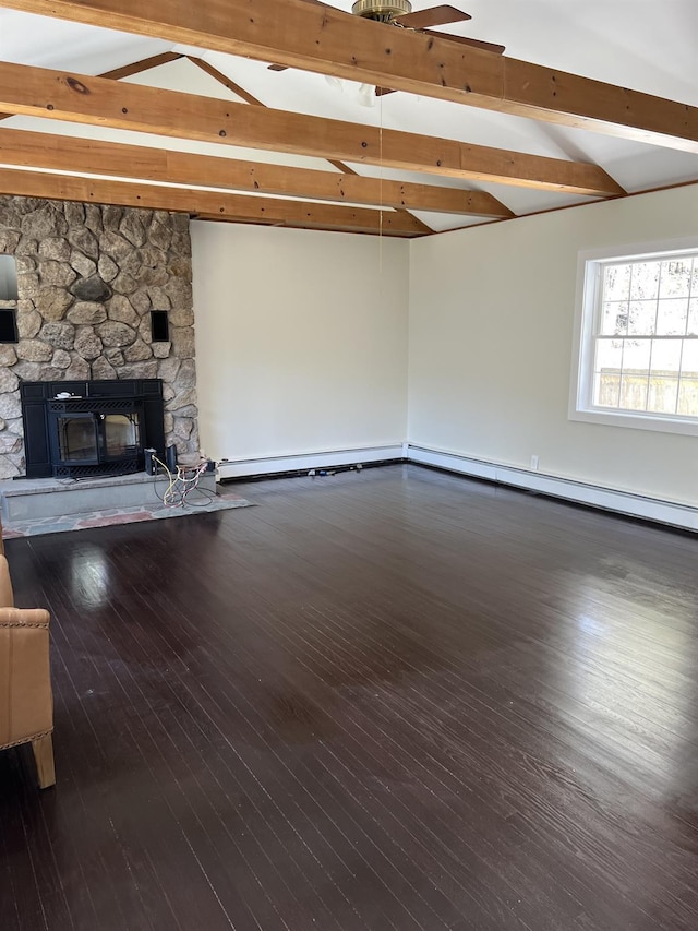 unfurnished living room featuring wood-type flooring, a stone fireplace, and vaulted ceiling with beams
