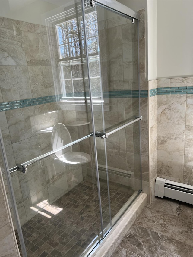 full bathroom with a baseboard radiator and a stall shower