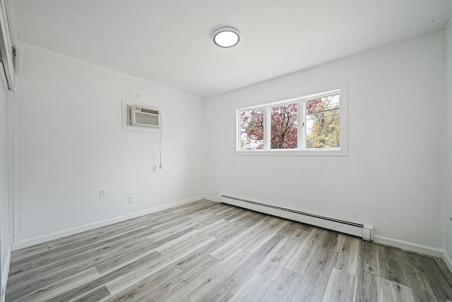 unfurnished room featuring baseboards, baseboard heating, an AC wall unit, and light wood-style flooring