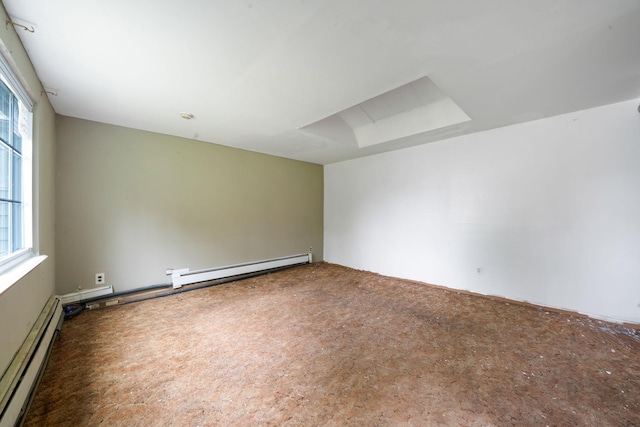 carpeted spare room featuring a baseboard radiator