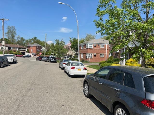 view of road with a residential view and street lighting