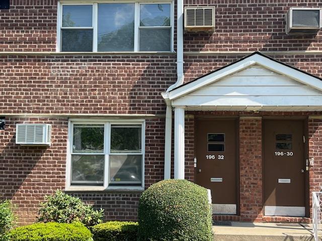 property entrance featuring brick siding