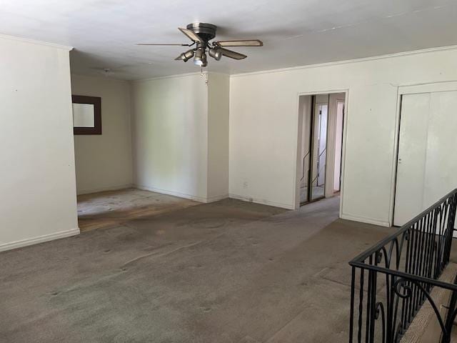 unfurnished room with carpet floors, baseboards, and ceiling fan