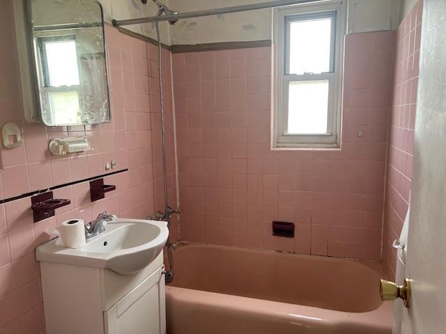 full bathroom featuring plenty of natural light, tub / shower combination, and vanity