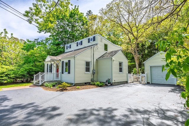352 Gibbs Pond Rd, Nesconset, NY 11767 - view of front facade with asphalt driveway, an outbuilding, a detached garage, view of scattered trees, and a shingled roof