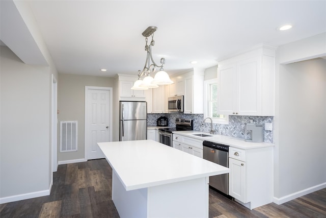352 Gibbs Pond Rd, Nesconset, NY 11767 - kitchen featuring appliances with stainless steel finishes, a sink, tasteful backsplash, white cabinetry, and recessed lighting