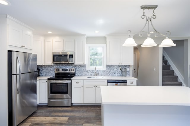 352 Gibbs Pond Rd, Nesconset, NY 11767 - kitchen with appliances with stainless steel finishes, a sink, decorative backsplash, dark wood-style flooring, and recessed lighting