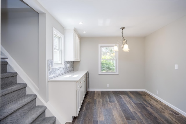 352 Gibbs Pond Rd, Nesconset, NY 11767 - kitchen with white cabinetry, light countertops, dark wood finished floors, tasteful backsplash, and decorative light fixtures